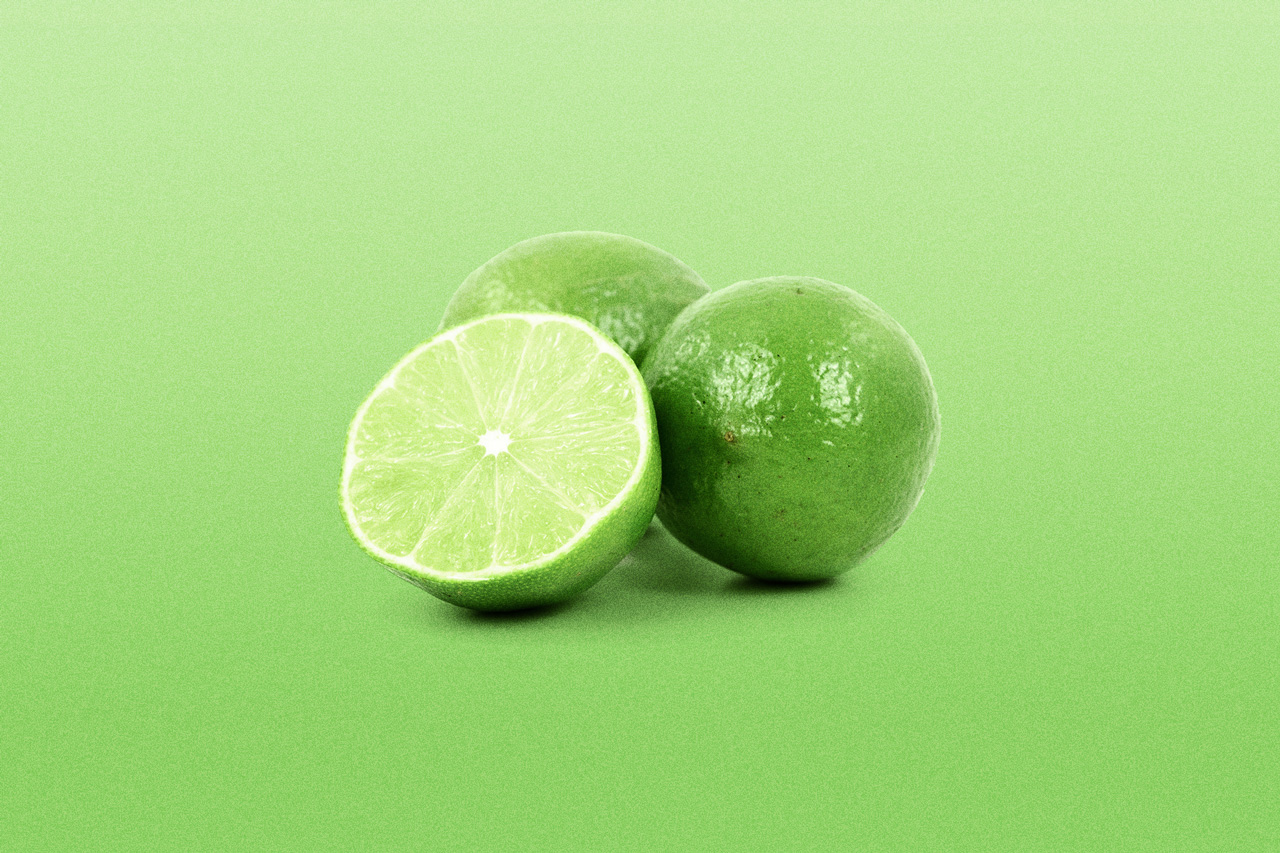 Limes on green background