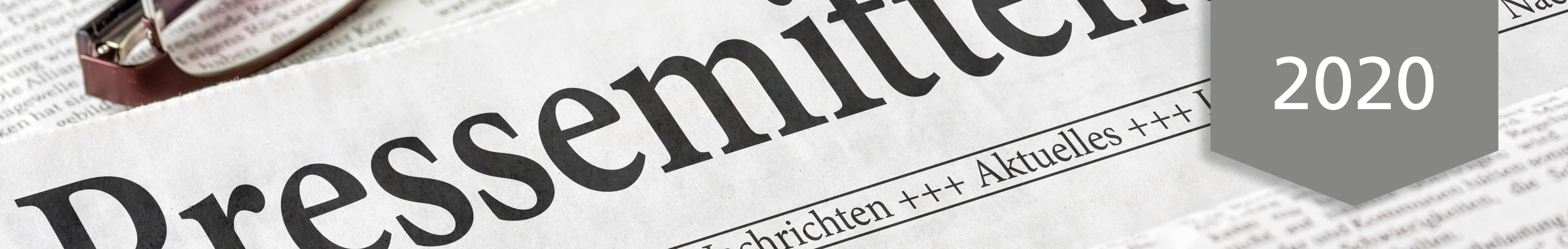Close-up of a newspaper showing the word 'Press Release' and a 2020 banner