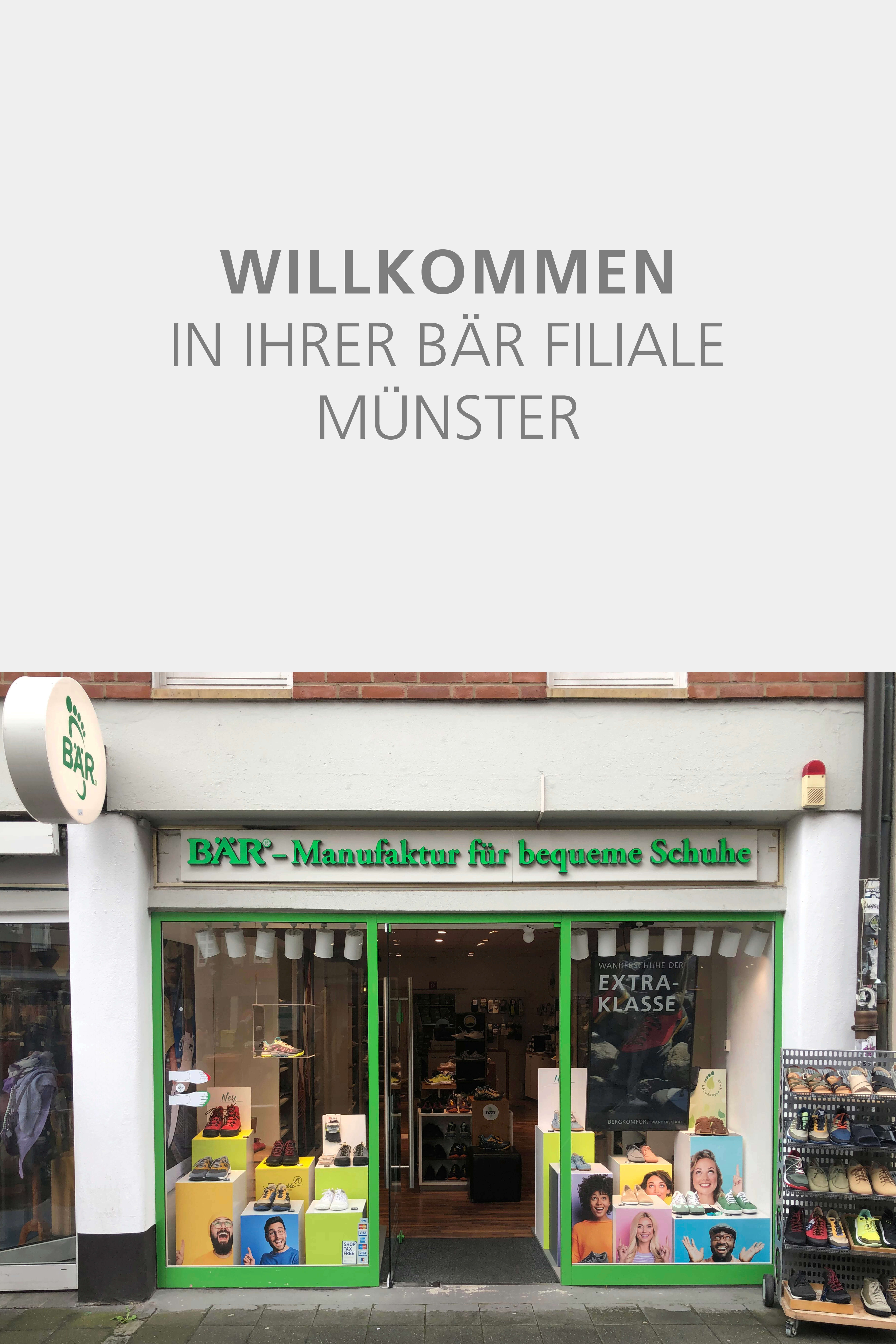 Exterior view of the BÄR shoe store in Münster, showcasing comfortable footwear and colorful displays.