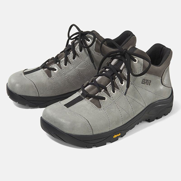 A pair of gray hiking boots featuring black laces and durable Vibram soles, designed for outdoor activities.