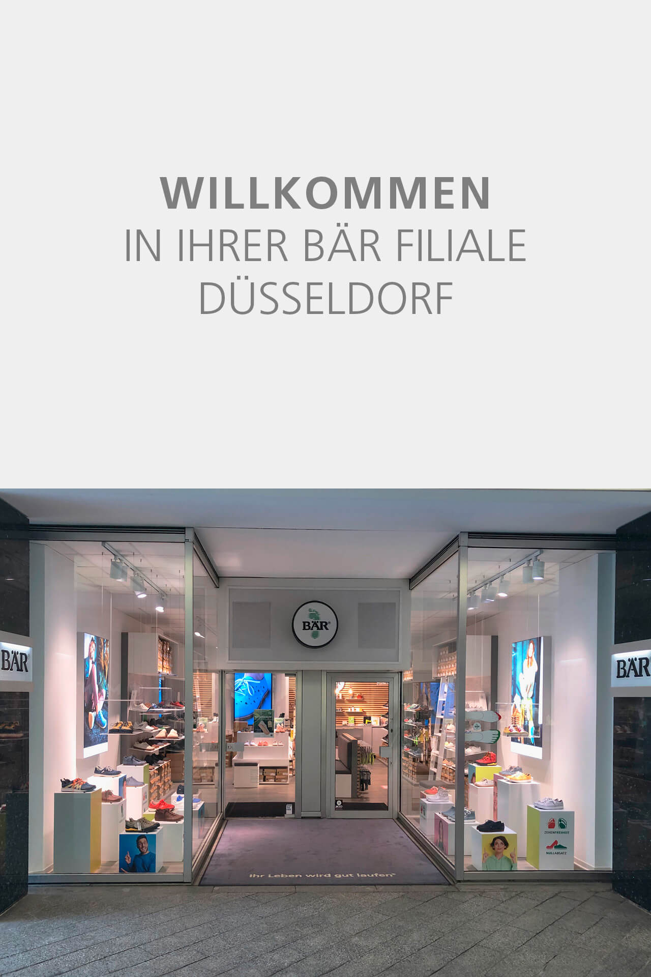 Front view of BÄR shoe store in Düsseldorf with glass doors and displayed footwear.