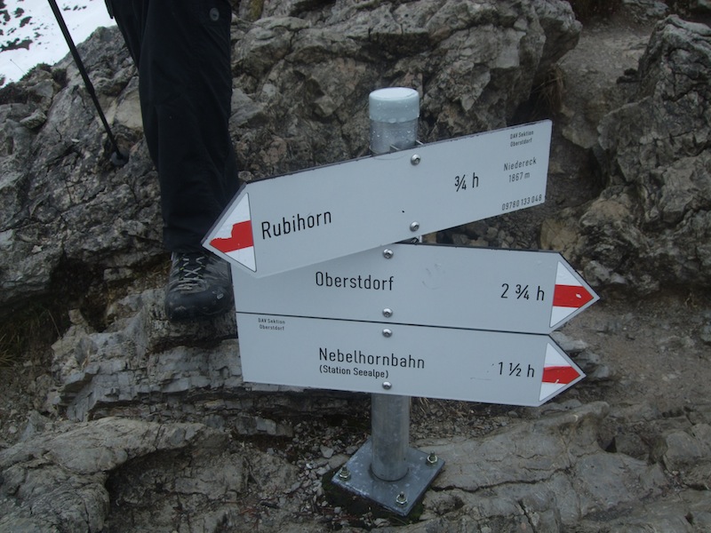 Mountain trail signpost with directions and distances to Rubihorn, Oberstdorf, and Nebelhornbahn