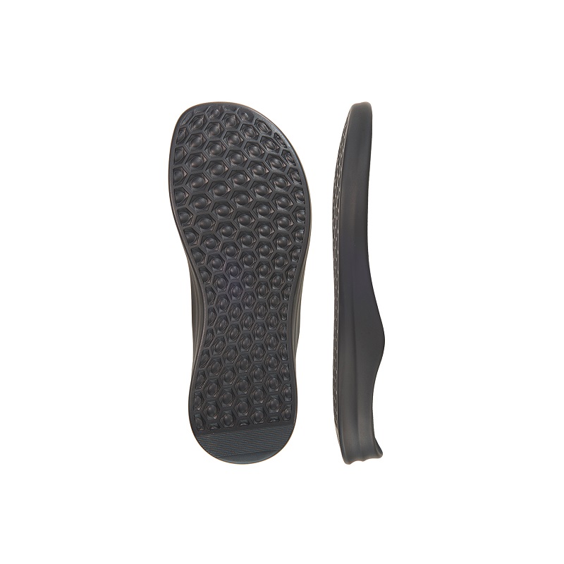 Pair of black rubber shoe soles, showing textured grip pattern, designed for durability and comfort