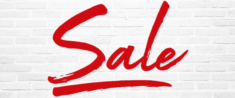 The word 'Sale' in bold red letters on a white brick background