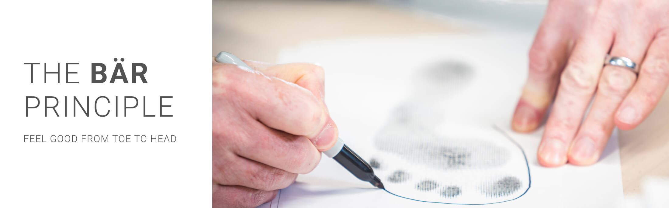 Person tracing a footprint with a pen, representing the BÄR Principle of comfort from toe to head.