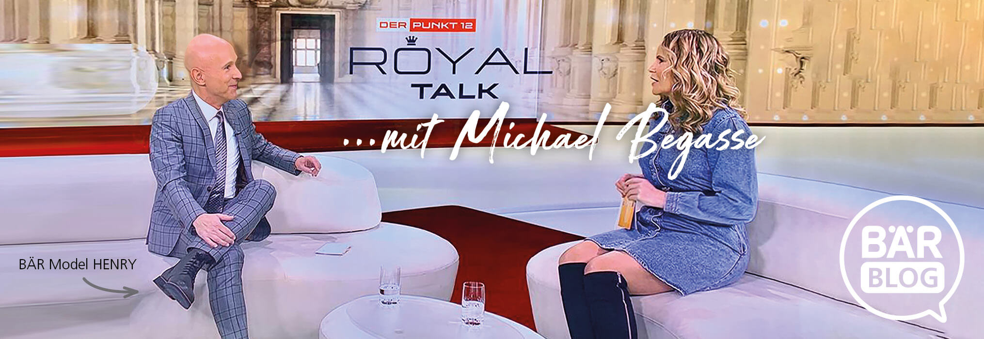 Host and guest sitting on a modern set during a Royal Talk show with Michael Begasse on Punkt 12.